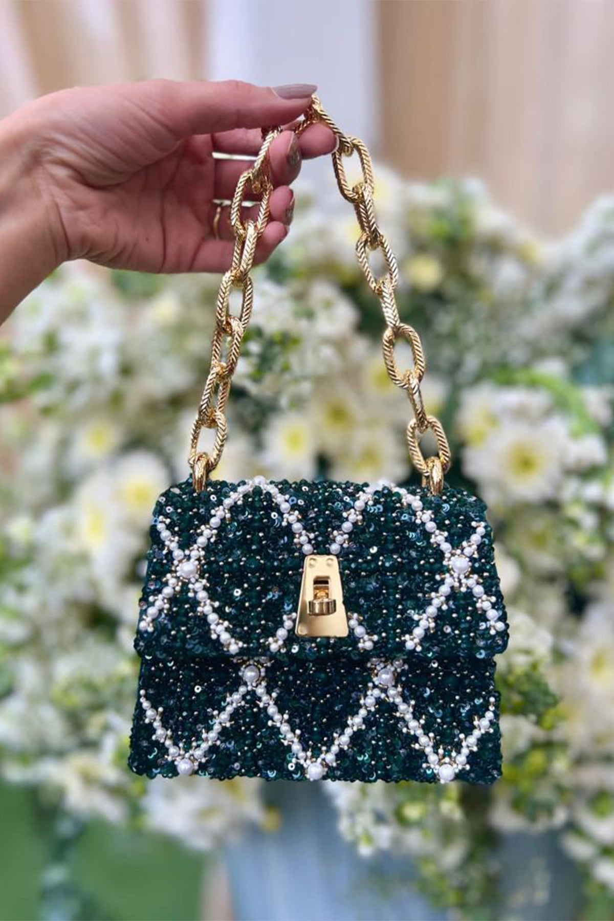 Tarini Manchanda with the Erica Emerald Handheld Mini Bag