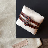 Hand tooled bracelet with knot detail